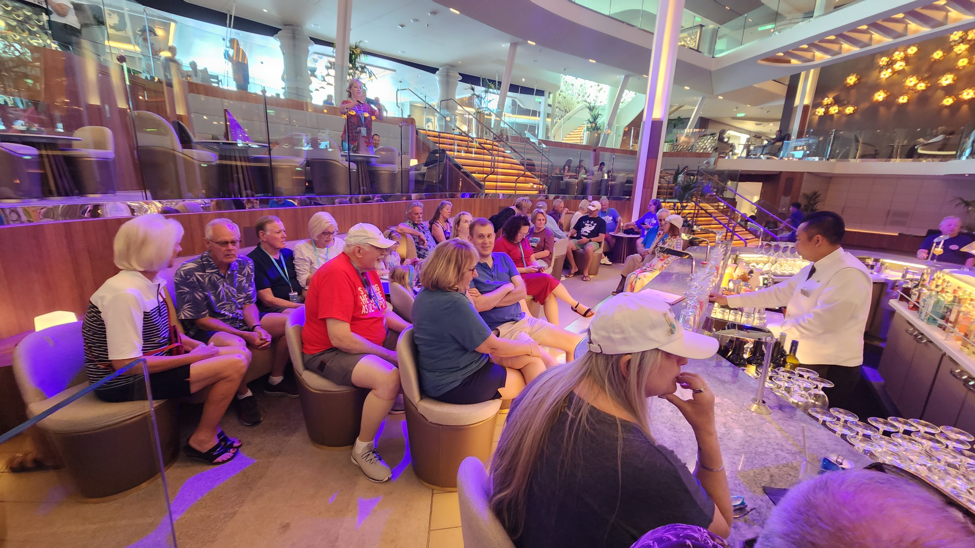 Cruise group gathered together for an onboard social event around the ship bar.