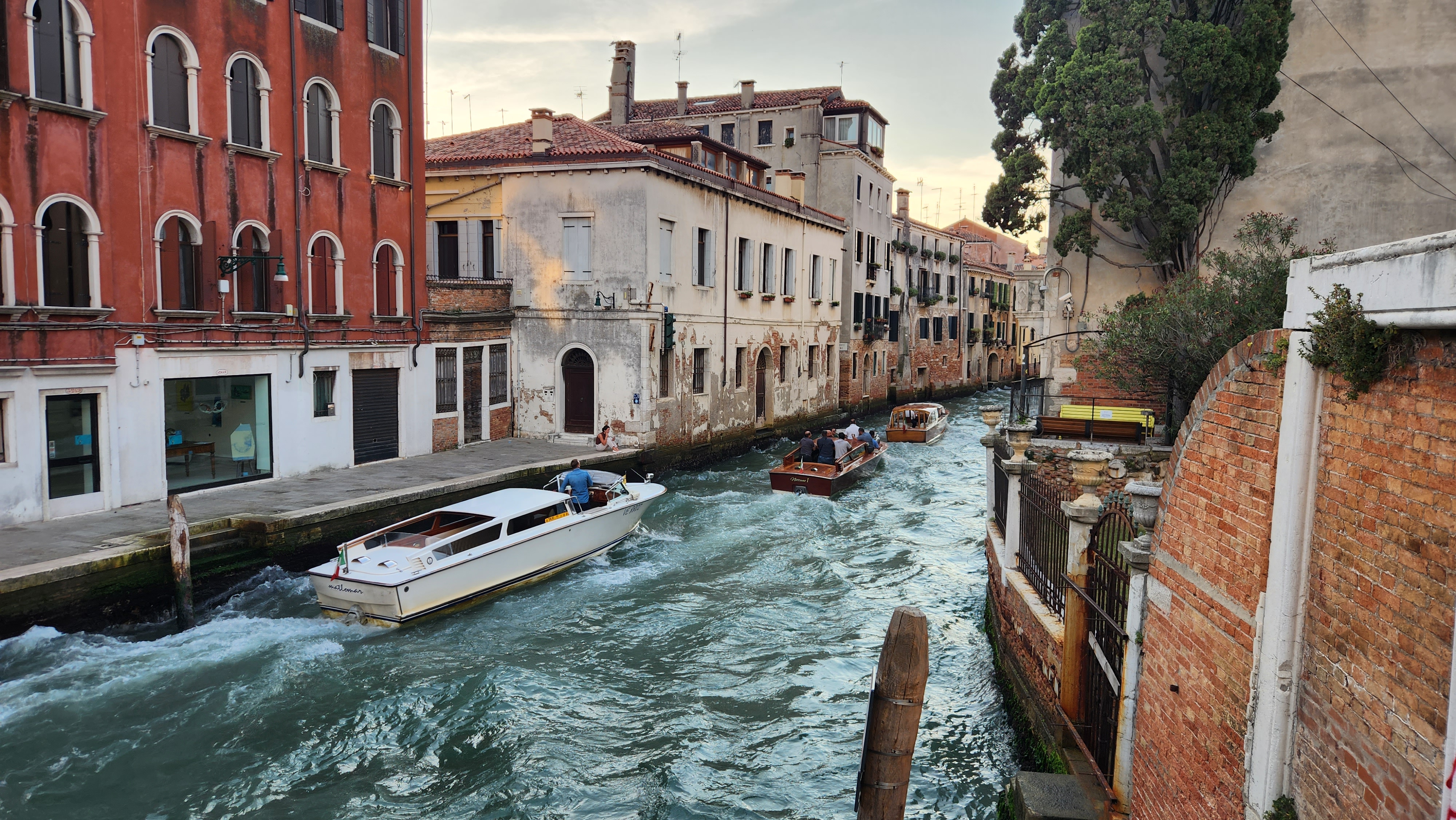 Venice canal with boats and historic buildings in Italy