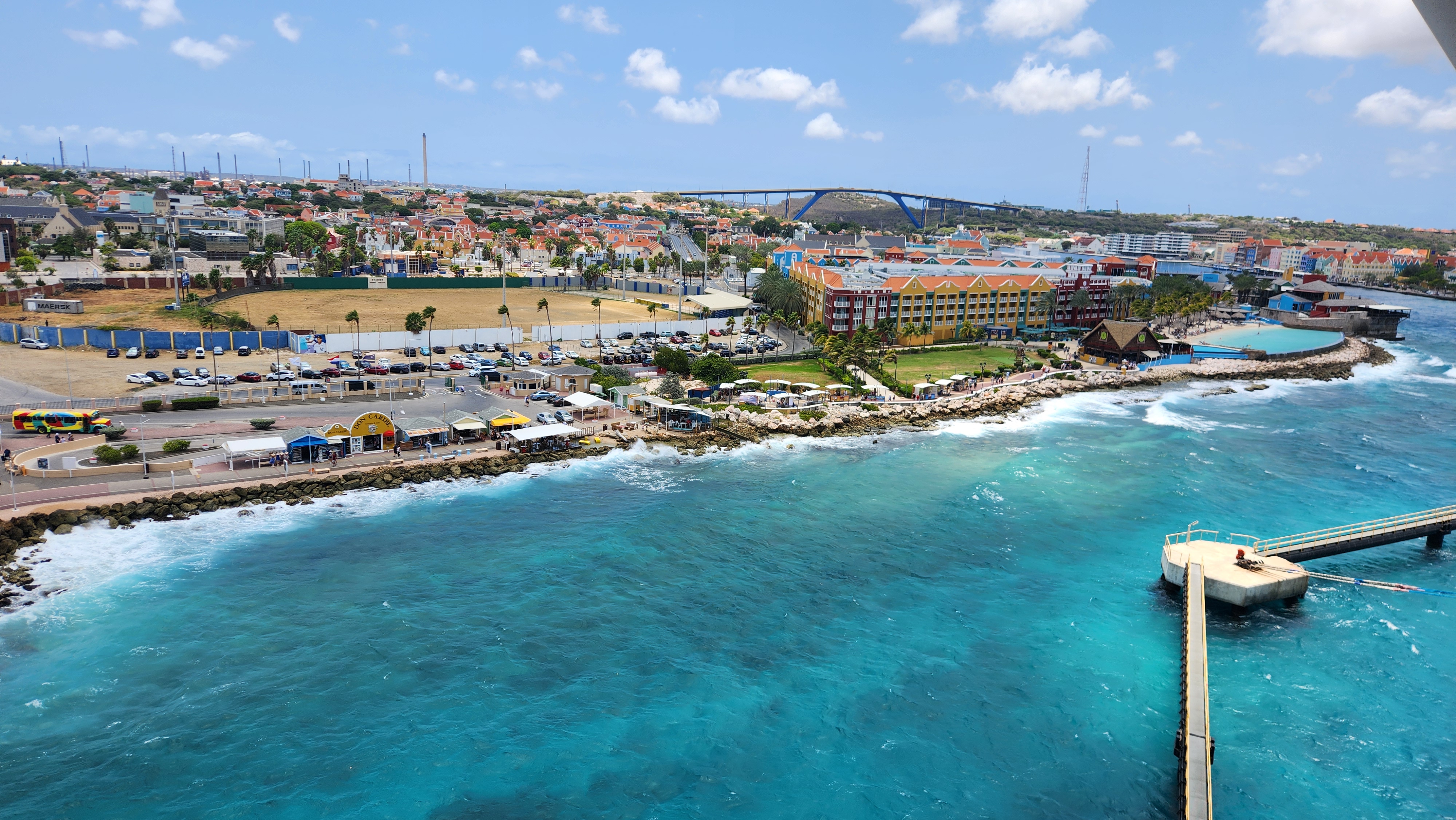 Colorful Caribbean coastal city beside bright blue water