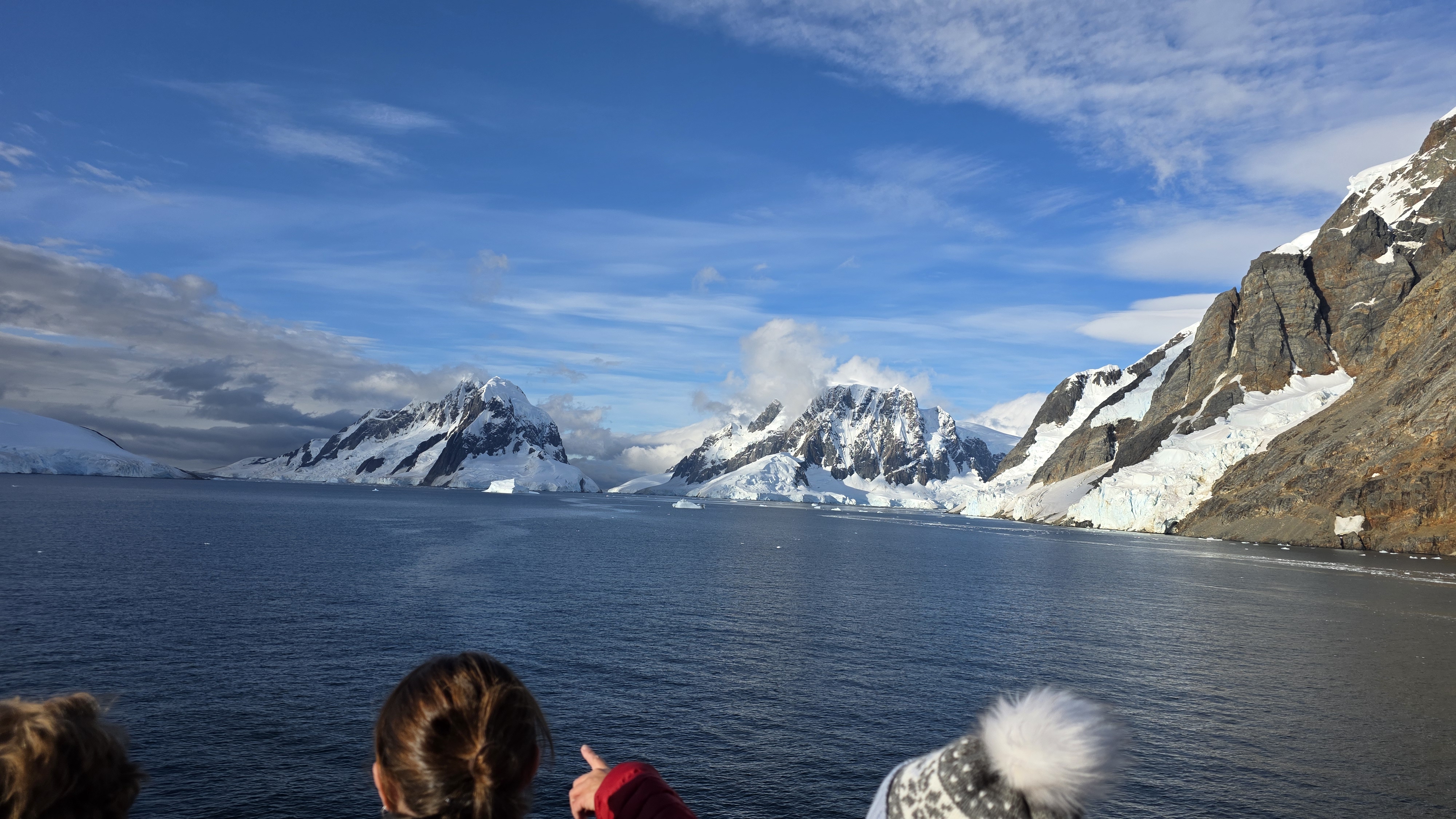 Snow-covered Antarctic mountains and coastal ice seen during our 2026 expedition