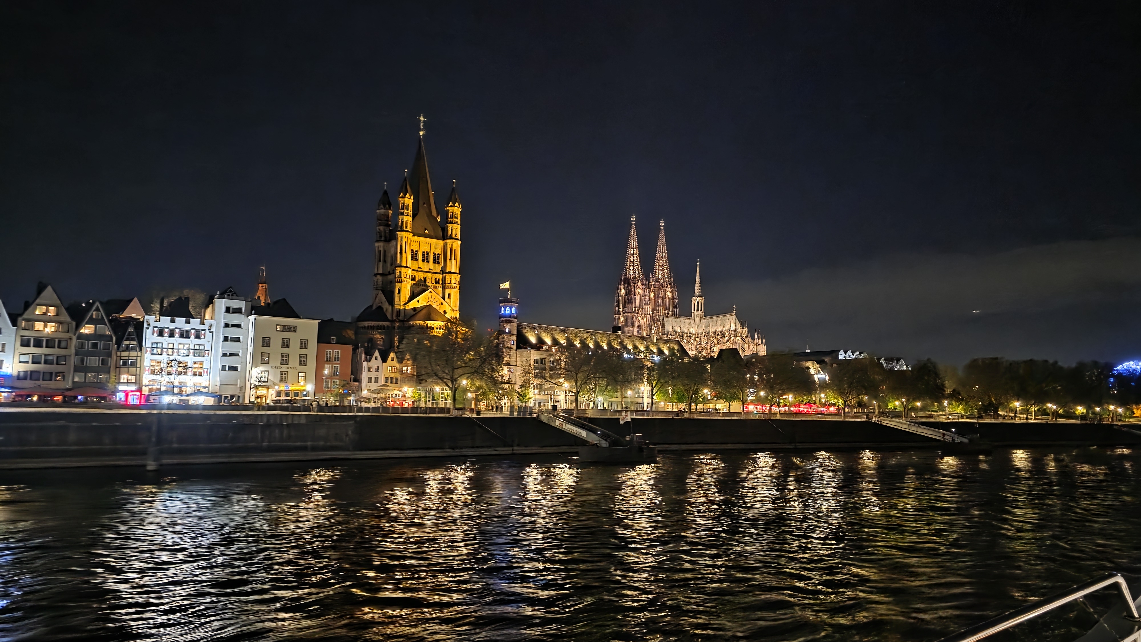 Cologne Cathedral and historic riverside skyline illuminated above the Rhine at night