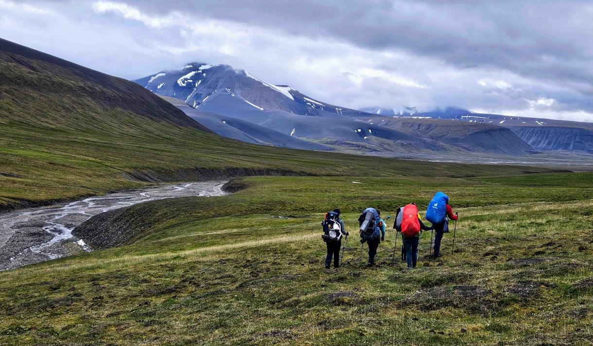 Aurora Expeditions guests hiking through the Svalbard landscape