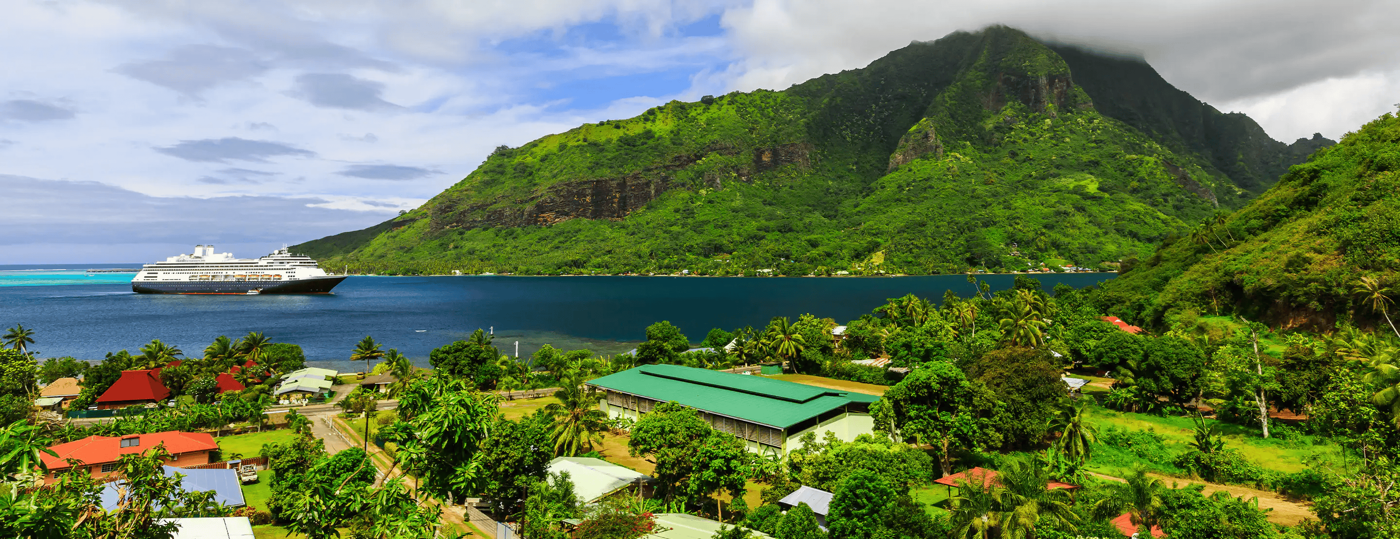 Cruise ship anchored beside the lush mountains of Moorea