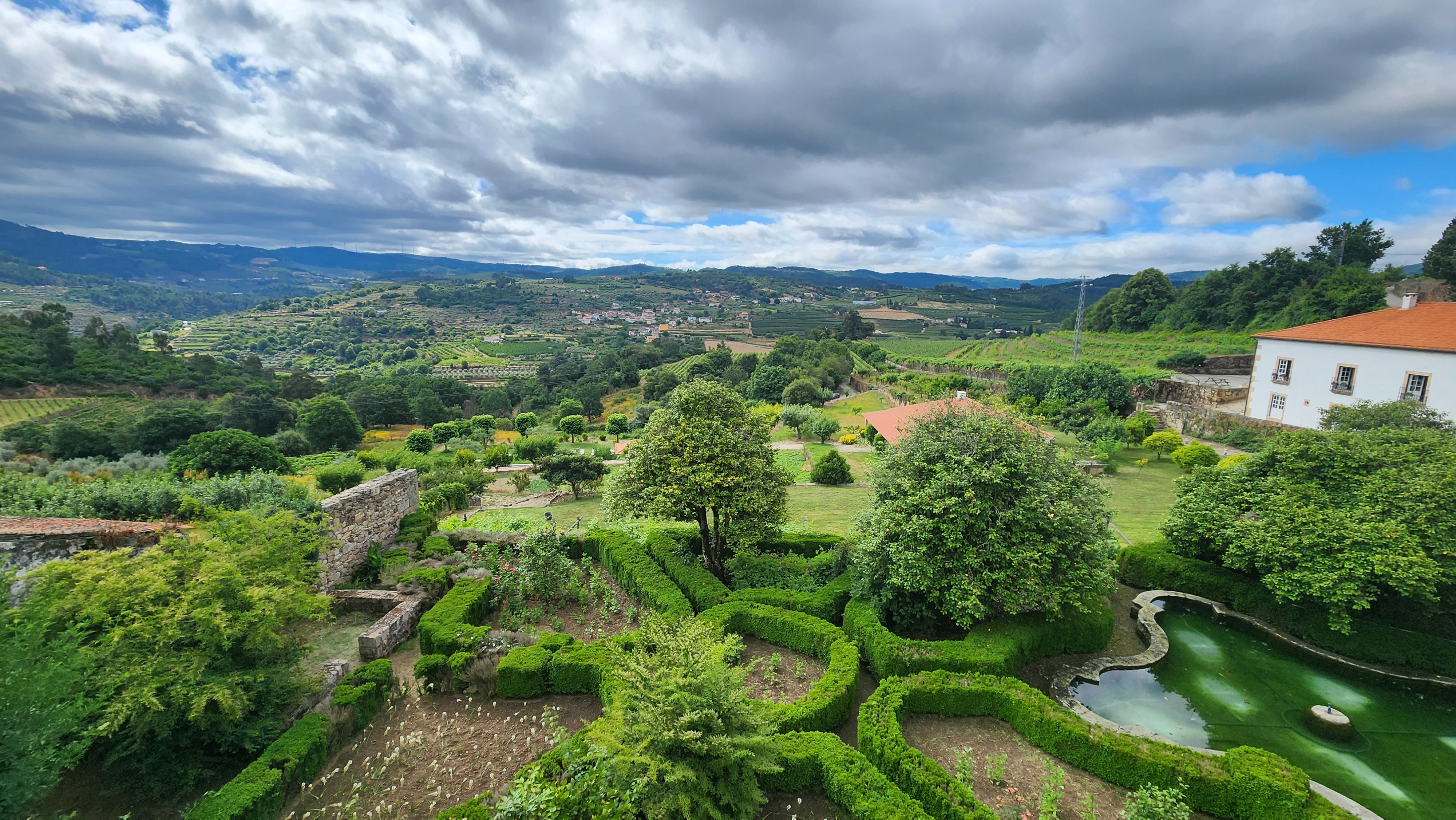 Scenic view of the Douro Valley with vineyards and formal gardens.